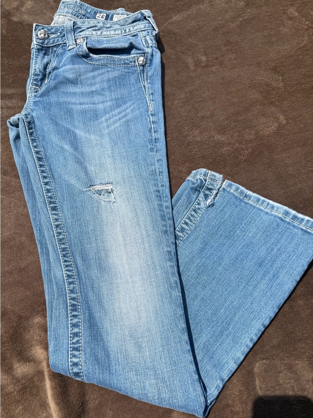 Miss Me brand blue denim jeans in a bootcut style